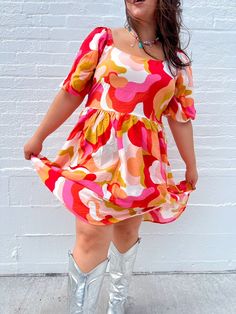 THE summer dress is here & ready to slay the season!! With the best warm tones and the cutest bow detail on the back, this dress is perfect for all occasions! Dress up with heels and jewelry, or keep it casual with sneakers and a cardigan! True to size. Self: 85% Rayon 15% Nylon Lining: 100% Polyester Puff sleeves and bow detail on the back Wear with sneakers, sandals, or heels Great length for our tall queens! Megan is 5'5 wearing a size 2X and typically wears a size 2X. Kristin is 5'10 and wea Businesses Photoshoot, Houston Photoshoot, Rainbow Closet, Colorful Photoshoot, Photoshoot Spring, Sunset Dress, Rainbow Clothes, Outfits Colorful, Colorful Wardrobe