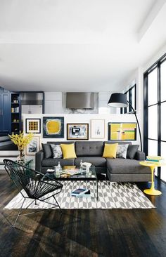 a living room filled with lots of furniture and decor on top of a hard wood floor