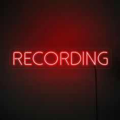 a red neon sign that reads recording on it's side in front of a black background