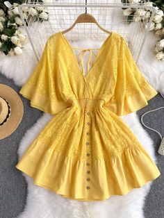 Envelop yourself in the romantic elegance of this beautiful yellow dress. Its lace detailing exudes a sophisticated charm, while the deep yellow shade offers a cheerful pop of color. The skirt flares out from a figure-hugging waist, creating a flirtatious and flattering profile. The bodice is graced with a line of delicate buttons, leading down to a ruffled hem that adds a touch of playful femininity. The open back, tied together with slender straps, offers a glimpse of skin in a tasteful displa Yellow Lace Dress For Spring, Elegant Yellow Mini Dress For Beach, Elegant Yellow Beach Mini Dress, Elegant Yellow Beach Dress, Yellow Lace Patchwork Dresses, Yellow Lace Dresses With Lace Patchwork, Spring Yellow Lace Mini Dress, Yellow Lace Patchwork Summer Dress, Yellow Lace Patchwork Dress For Summer