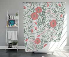 a bathroom with a flower shower curtain and shelf on the wall next to the bathtub