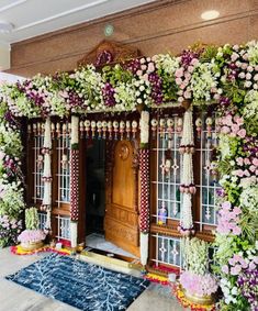 an entrance decorated with flowers and greenery