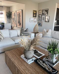 a living room filled with lots of furniture and pictures on the wall above it's coffee table