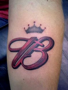 a tattoo with the letter b on it's arm and crown in the middle