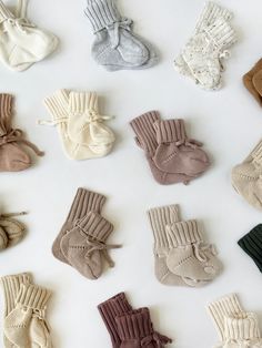 many pairs of baby socks laid out on a white surface