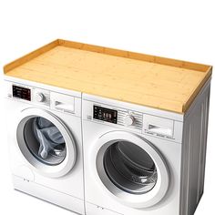 a white washer sitting next to a dryer on top of a wooden cutting board