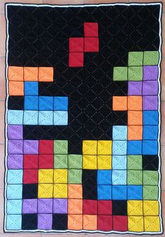 a quilt made to look like a game with blocks and squares on the bottom half