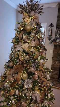 a christmas tree decorated with gold and silver ornaments