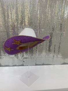 Lets go Tigers!! If you are heading to a tailgate party, football game or attend LSU, this hat is for you! Ready for those who want to stand out and have the most perfect accessory to their outfit. It is also a perfect birthday gift, graduation gift or Christmas gift to a family member or friend! This hat features: White straw hat Purple rhinestones on both brims Gold Stars on both brims Matching purple hat band Gold rhinestone trim on edges Sizing: Our white hats are a one size fits all! The ba Eras Concert, White Hats, Go Tigers, Purple Hat, 16 Birthday, Purple Hats, Tailgate Party, Rhinestone Trim, Cowgirl Outfits