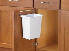 The 9 qt in-cabinet door-mounted trash can, from Real Solutions by Knape & Vogt, conveniently hides your waste or recycling right behind the cabinet door. Constructed with white polymer material, the bin wipes clean with ease, and can be removed from the frame for more thorough cleaning and easy trash removal. Installs easily with just 2 screws. Knape & Vogt 9-Quart White Plastic Indoor Kitchen Lidless Trash Can | DWB975-W Rv Storage Solutions, Pull Out Trash Cans, Inside Cabinets, Kitchen Waste, Kitchen Trash Cans, Waste Bin, Tiny Kitchen, Recycle Trash, Trash Bins