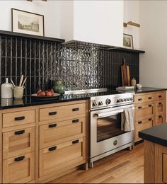 a kitchen with an oven, counter tops and wooden cabinets is shown in this image