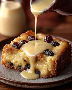 a piece of bread with raisins and caramel sauce being drizzled over it