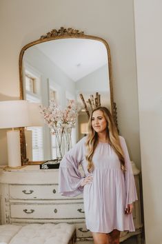 This is a lavender long sleeve flowy dress with bell sleeves and a keyhole tie back. The model is wearing a size small. Long Sleeve Flowy Dress, Lavender Dress, Dress With Bell Sleeves, Lavender Dresses, Frankies Bikinis, Bell Sleeve Dress, The Model, Sports Illustrated, Flowy Dress