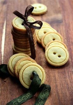 some cookies are stacked on top of each other and tied with a brown ribbon in front of them