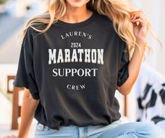 a woman wearing a t - shirt that reads lauren's marathon support crew on it