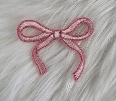 a pink bow on top of white fur