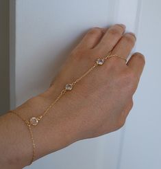 Hand chain is a subtle unique way to wear jewelry. Chain is made of 14k gold fill or sterling silver. Three swarovski crystals anchor the piece together. Bracelet is adjustable and can fit a wrist 6-7 inches or 7-8 inches. The ring piece is 3 inches and the middle chain is approx 4 inches. If you need a larger ring size, let me know when you checkout. It's best to give me the length from the knuckle of the finger you are going to wear it on to your wrist so I can make the middle chain as accurat Silver Hand Chain, Chain Harness, Wedding Earrings Drop, Jewelry Chain, Classy Jewelry, Large Ring, Hand Chain, Bar Bracelets, Studio City