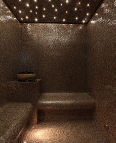 a very nice looking bathroom with some lights on the ceiling and tiled walls in it