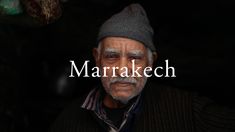 an old man wearing a hat and jacket with the words marrakech on it