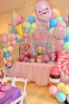 a party with balloons, candy and decorations