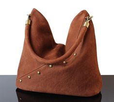 If you like the durability and texture of suede and real leather - this Ideal Brown hobo bag for everyday in addition to be elegant, original and comfortable, this bag makes you unique. Indeed every bags in our collection are unique, everyone can have a high know how and original design bag. We always exploring new designs and details to offer the best quality as well as a large offer of bags in terms of your wishes (height, color, texture). These real leather bags you will be essentials to put Studded Handbag, Real Leather Bags, Suede Bag, Design Bag, Heavy Bags, Handmade Bag, Wardrobe Basics, Leather Bags, Soft Suede