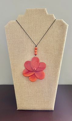 Handmade in Ecuador Necklace length: Adjustable Length 21 - 38 Inches Rose width: 3 Inches Materials: Tagua Nut Due to this item being handmade and the nature of the Tagua Nut the size and the color may vary from piece to piece Handmade Rose Flower Pendant Necklace, Handmade Rose Flower Necklace, Adjustable Pink Flower-shaped Necklace, Pink Adjustable Flower Shaped Necklace, Handmade Rose Flower Pendant Jewelry, Adjustable Rose Necklace For Gift, Adjustable Rose Necklace Perfect For Gifting, Handmade Rose Flower Jewelry, Coral Adjustable Necklace For Gift