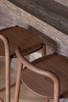 two wooden stools sitting next to each other