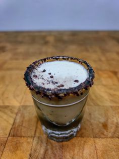 a drink sitting on top of a wooden table