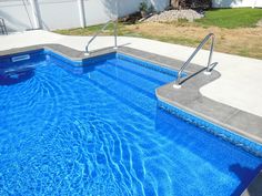 an empty swimming pool with steps leading up to it