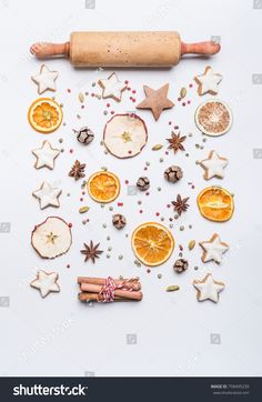 an assortment of cookies, oranges and spices arranged in the shape of a christmas tree