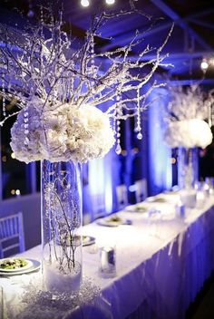 an image of a table setting with flowers and candles on the tables at a wedding