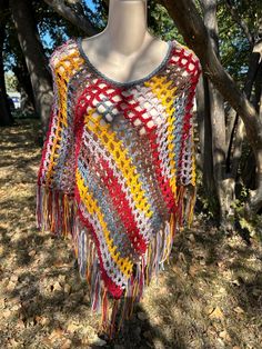 This poncho was made using very soft 100% acrylic yarn.  The colorway is "Bonfire". It is one size fits all depending on how you want to wear it.  My model is a size 8-10 shown in the last 2 pics.  The last picture is of the back side of the poncho. It is ready to ship!     I'm listing several in different colorways and sizes.  They are so pretty with jeans and boots ♥... the perfect accessory for a cool Fall, Winter, or Spring Day. I made this poncho using my own original pattern. If you would Poncho Au Crochet, Ladies Poncho, Crochet Poncho, Autumn Colors, Mead, Spring Day, Ponchos, Acrylic Yarn, The 3