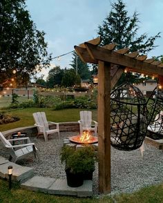 an outdoor fire pit with chairs around it