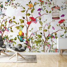 the wallpaper in this room is painted with colorful flowers and birdcages on it