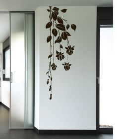 the wall is decorated with an image of leaves and flowers on it's side