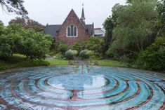 an artisticly designed circular garden in front of a church