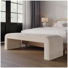 a bed with a foot board sitting on top of it