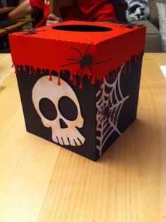 a paper box with a skull and spider on it