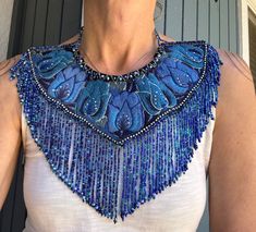 a woman wearing a blue beaded necklace