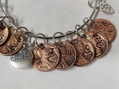 Pennies from. Heaven charm bracelet. Customized with the date and initial of the corresponding family members Pennies From Heaven, Charm Necklaces, Alex And Ani Charm Bracelet, Family Members, Arm Band, Mother's Day Gifts, Charm Necklace, Penny, Etsy Accessories