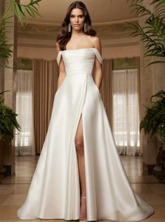 a woman in a white wedding dress with a slit