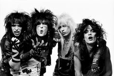 four women with black hair and piercings posing for the camera