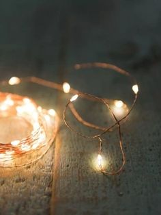 some lights that are sitting on the floor together and one is lit up with string lights