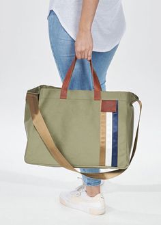 Super spacious - the everyday tote bag This is the ideal carry-all - roomy enough to fit all your essentials and the neutral sage colour will go with any outfit from casual to business. Super versatile and generously sized, it features an open top for easy access, genuine leather handles and a cross body strap for when you want to go hands free. Overview Generous internal capacity Ultra-wide opening 4 open internal pockets Separate zipped pouch Cross-body strap Reinforced base Stores flat L43cm Everyday Khaki Shoulder Bag With Leather Handles, Khaki Shoulder Bag With Leather Handles For Everyday, Khaki Canvas Tote Bag For Everyday, Versatile Khaki Tote Canvas Bag, Khaki Tote Satchel For Everyday, Everyday Green Rectangular Travel Bag, Green Canvas Tote Bag For Everyday, Green Everyday Tote Canvas Bag, Green Everyday Canvas Tote Bag