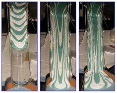 three different views of a tall vase with green and white designs on the top, side by side