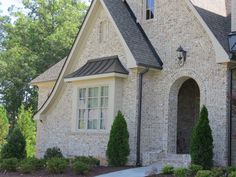 a brick house with white trim and windows