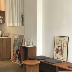 a kitchen with wooden cabinets and stools in it