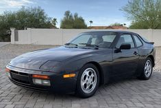 a black sports car parked in a driveway