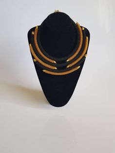 This necklace is 100% handcrafted using fine beads. *Simple yet stylish piece to add to your jewelry set* *Perfect for weddings, African themed events or any other occasion. Main color; gold and black. Dimensions; 18 inches around the neck. **Buy multiple items and pay shipping for 1 item only.The rest ships free. More neckleces here; https://www.etsy.com/shop/TribalTess?ref=seller-platform-mcnav&section_id=21306083 Back to my shop; https://www.etsy.com/shop/TribalTess?ref=seller-platform-mc Gold Necklaces With Black Beads For Party, Gold Bib Necklace With Large Beads For Jewelry Making, Adjustable Gold Beads Necklace, Gold Choker With Black Beads For Parties, Adjustable Gold Beaded Necklaces With Large Beads, Adjustable Gold Beaded Necklace With Large Beads, Elegant Gold Necklaces With Black Beads, Elegant Gold Necklace With Black Beads, Elegant Gold Beaded Necklace With Tiny Beads