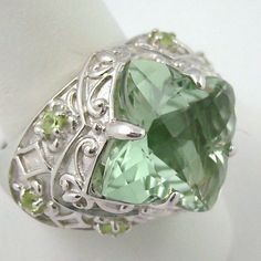 ******Price Is Firm - Final Sale****** Victoria Wieck 6.1ct Prasiolite & Peridot Sterling Silver Ring. Checkerboard-Faceted, Rounded, Geometric Prasiolite (16mm) In Prong Setting. Four-Lobed Frame Features Fleur-De-Lis Designs And Scrolling Metalwork Detail. Wide Shoulders Engraved With Diamond Shapes And Four-Lobe Patterns Accented With Prong-Set, Round Peridot (2mm) Gems. Ring Measures Approx. 11/16" L X 15/16" W. Boxed. Elegant Peridot Gemstone Gift, Elegant Peridot Gemstones For Gifts, Elegant Peridot Gemstones As Gift, Elegant Multi-stone Peridot Gemstones, Formal Peridot Gemstones For May Birthstone, Fine Jewelry Peridot Gemstones For Formal Occasions, Formal Green Amethyst Ring With Accent Stones, Elegant Green Peridot Gemstones, Elegant Green Amethyst Ring In Sterling Silver